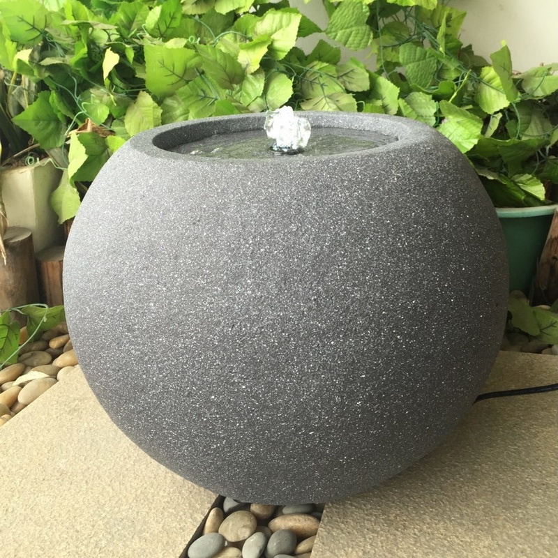 Circular water fountain in stone surface for garden decoration